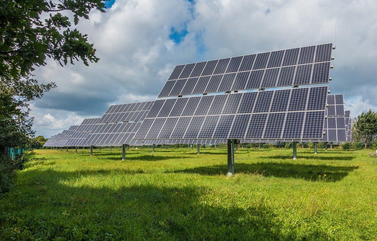 An array of solar panels, which could be improved by nanomaterials, stands in a field.