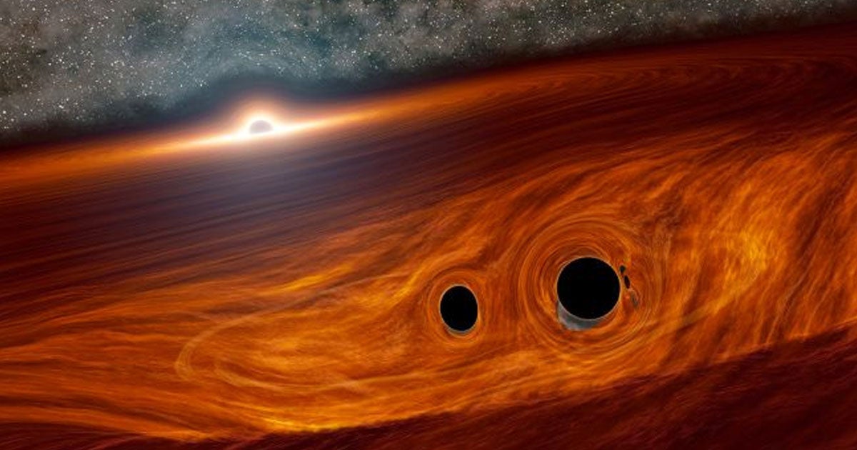 Researchers found an incredibly rare explosion that they think was caused by two black holes merging while orbiting an even larger one.