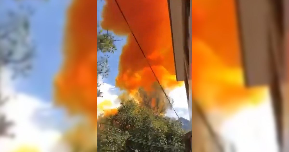 One of China's Long March 4B rocket boosters exploded in a cloud of orange smoke not far from a school after a successful launch.