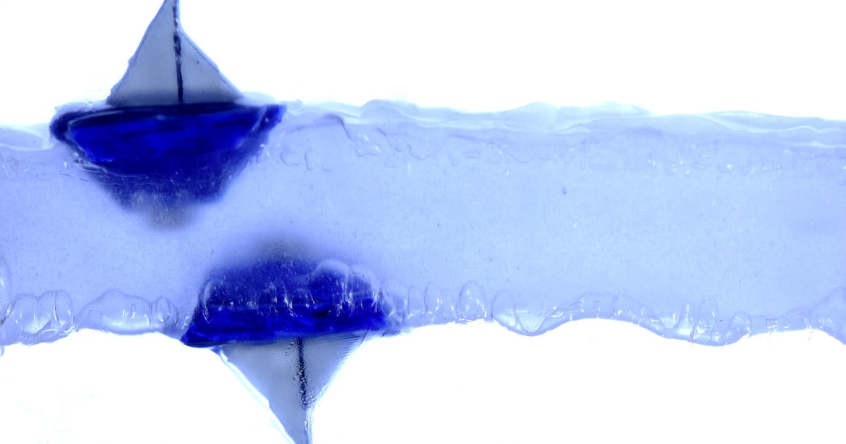 In an experiment, a team of scientists have created a levitating fluid that allows a tiny boat to float both on top of it — and below it.