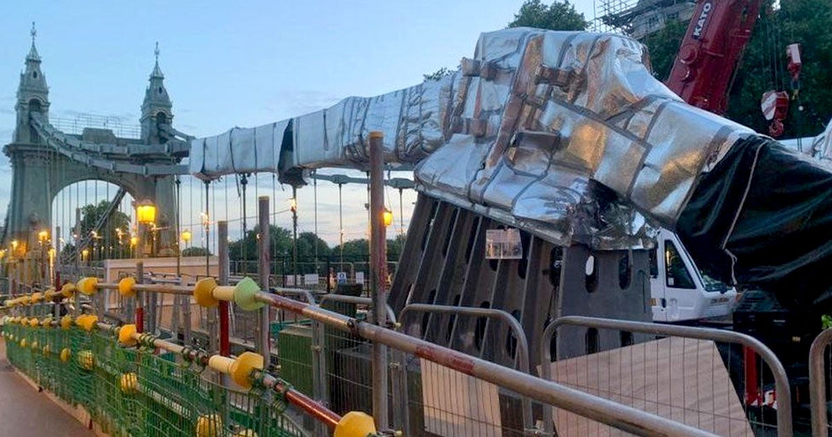 The UK — which has announced a "red warning" for extreme heat — weapped London's 135-year-old Hammersmith Bridge silver foil to keep it from cracking.