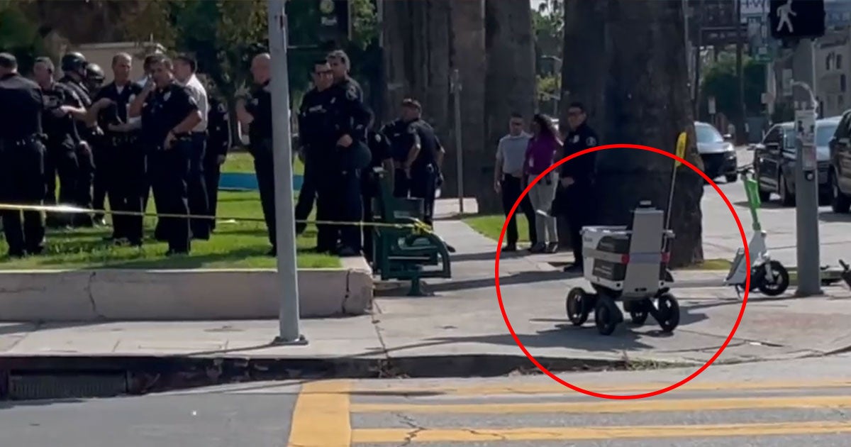 A food delivery robot threw caution to the wind and forced itself across a police line in the name of duty.