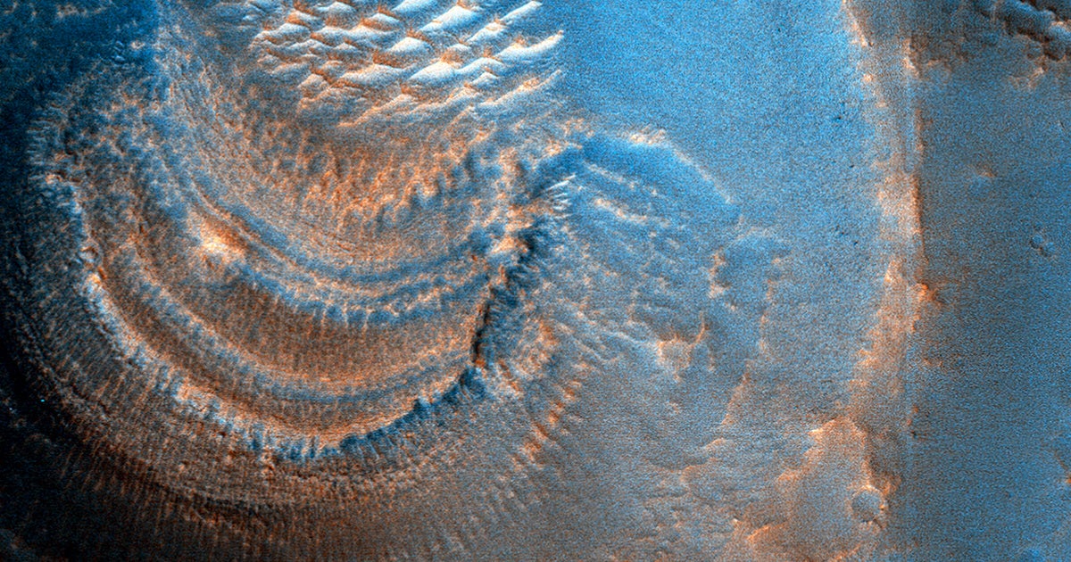 NASA's Mars Reconnaissance Orbiter has captured images of deposits forming "mysterious shapes" inside massive craters.