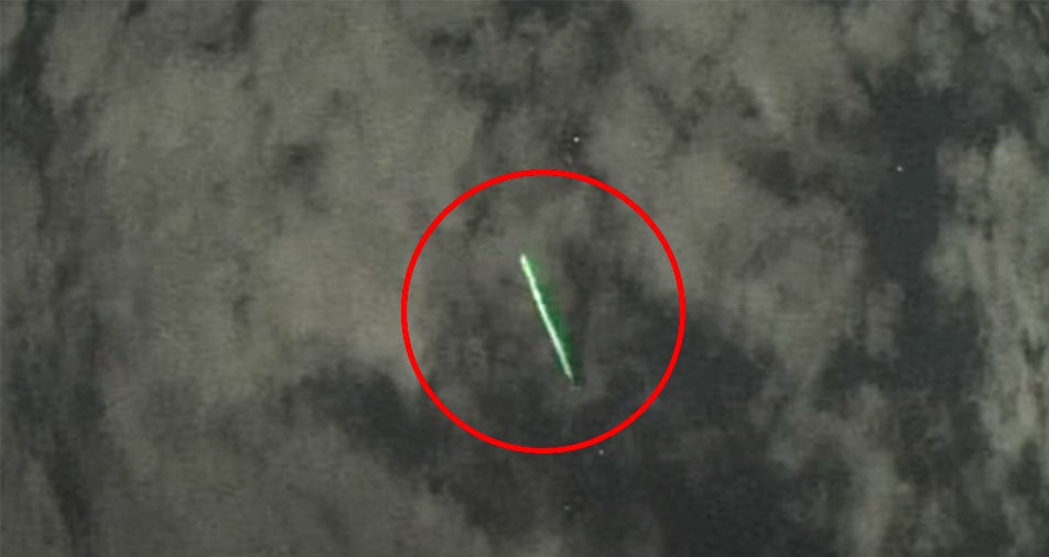 A Japanese astronomer spotted green streaks of light passing over a cloudy sky, which, as it turns out, were shot out by NASA's ICESat-2 satellite.