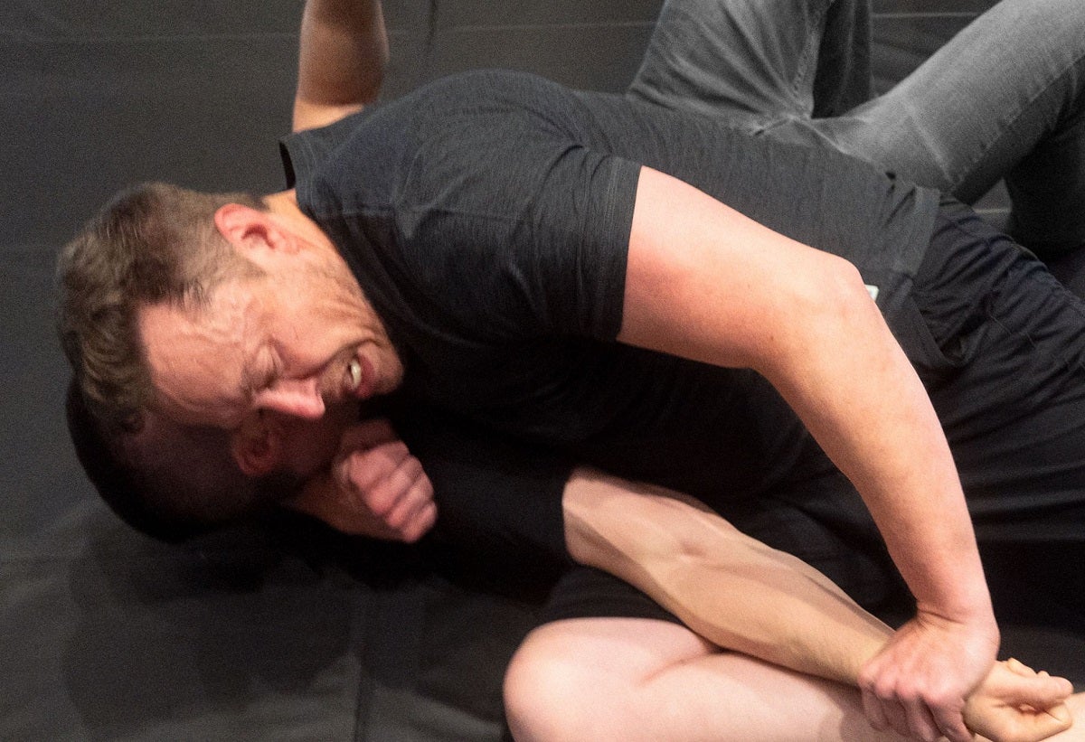 Elon Musk grappled with a podcaster on a mat, stoking the hype for a possible caged fight brawl with fellow billionaire Mark Zuckerberg.