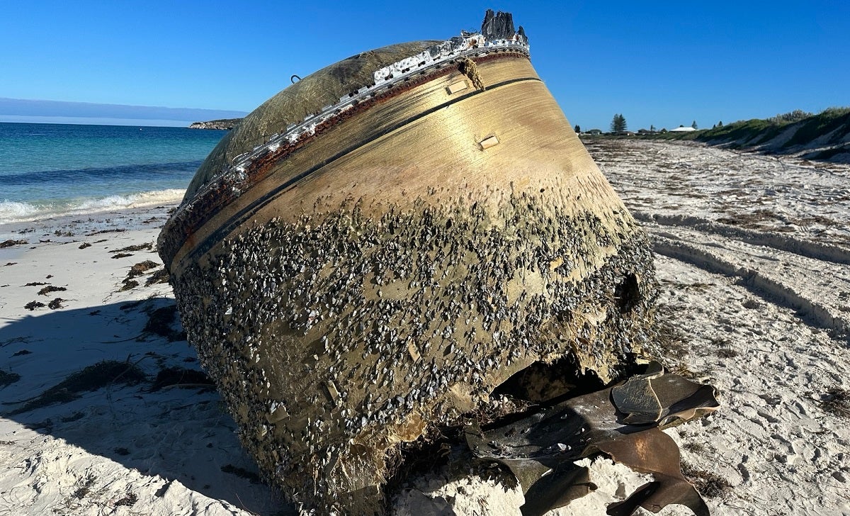 A golden-colored, cylindrical object was discovered by beachgoers in Australia on Sunday, as authorities still try to determine its origin.