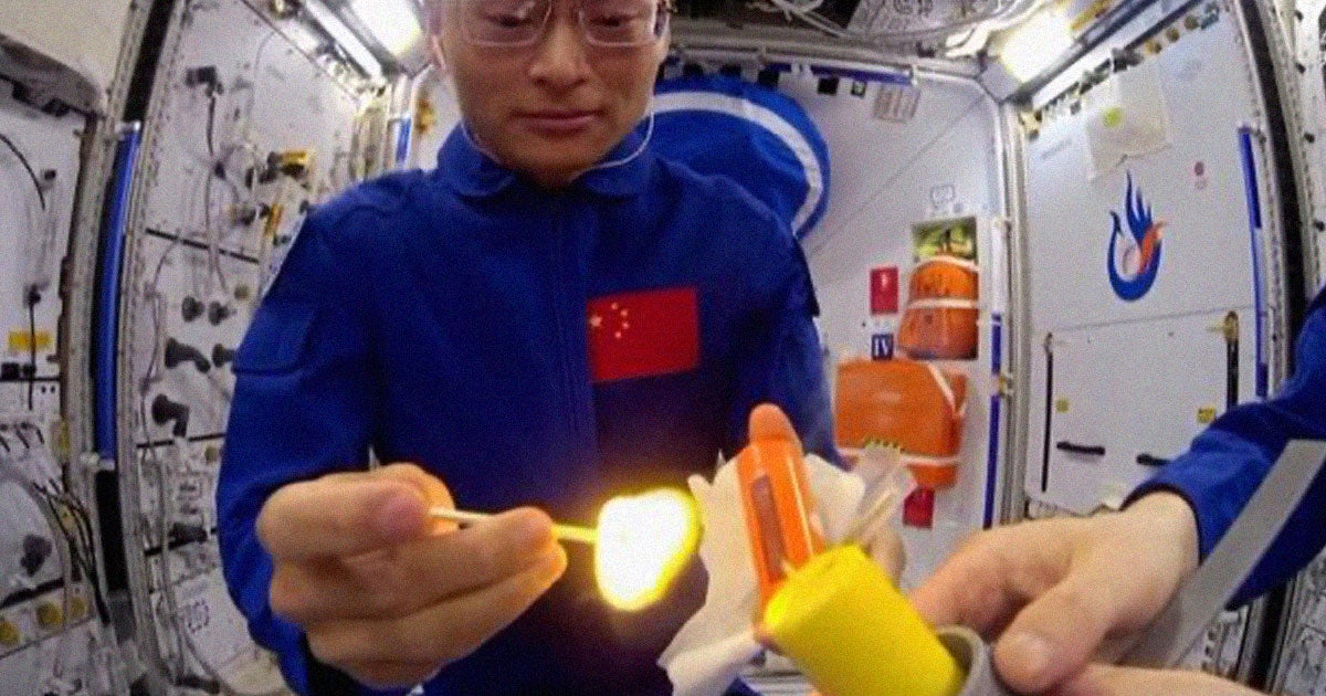 Two astronauts on board China's Tiangong space station have lit a candle with a match during a live broadcast.