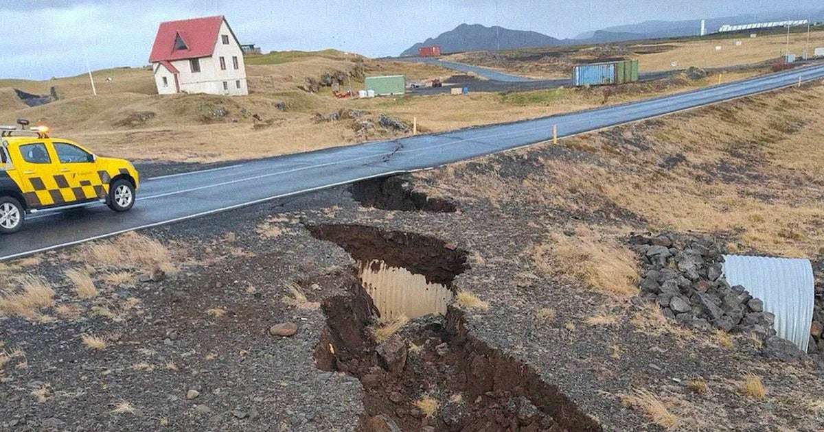 New aerial footage shows a massive crack splitting a town in Iceland in half and sending ominous steam into the air.