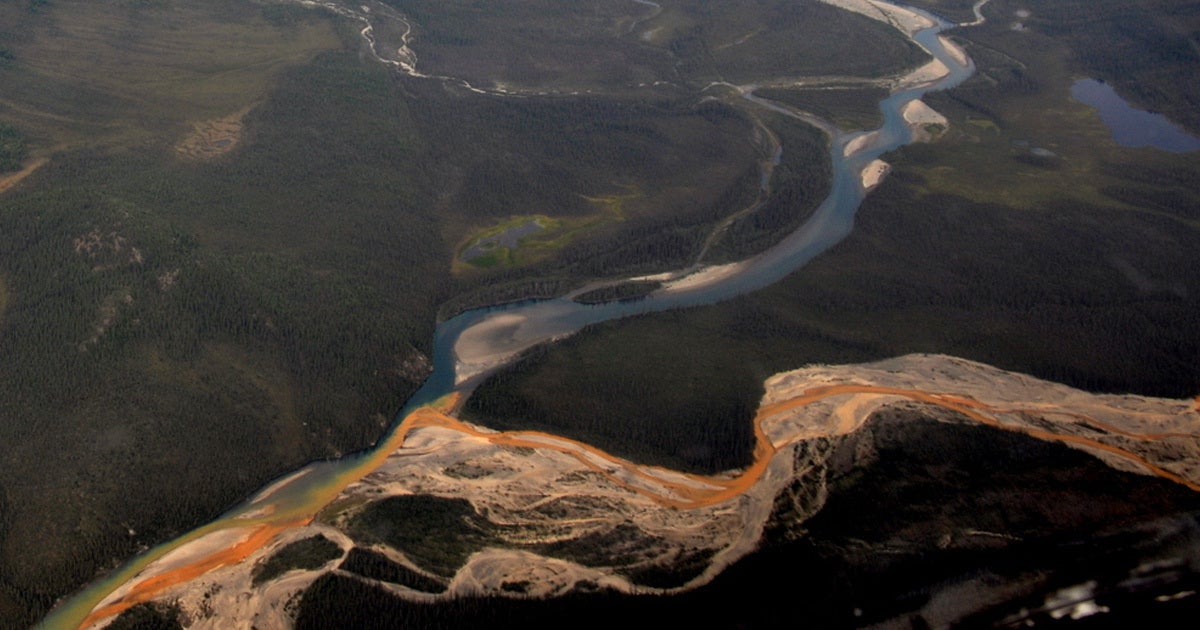 Global warming is thawing permafrost in Alaska and turning remote rivers from pristine glacier blue to rusty bright orange.