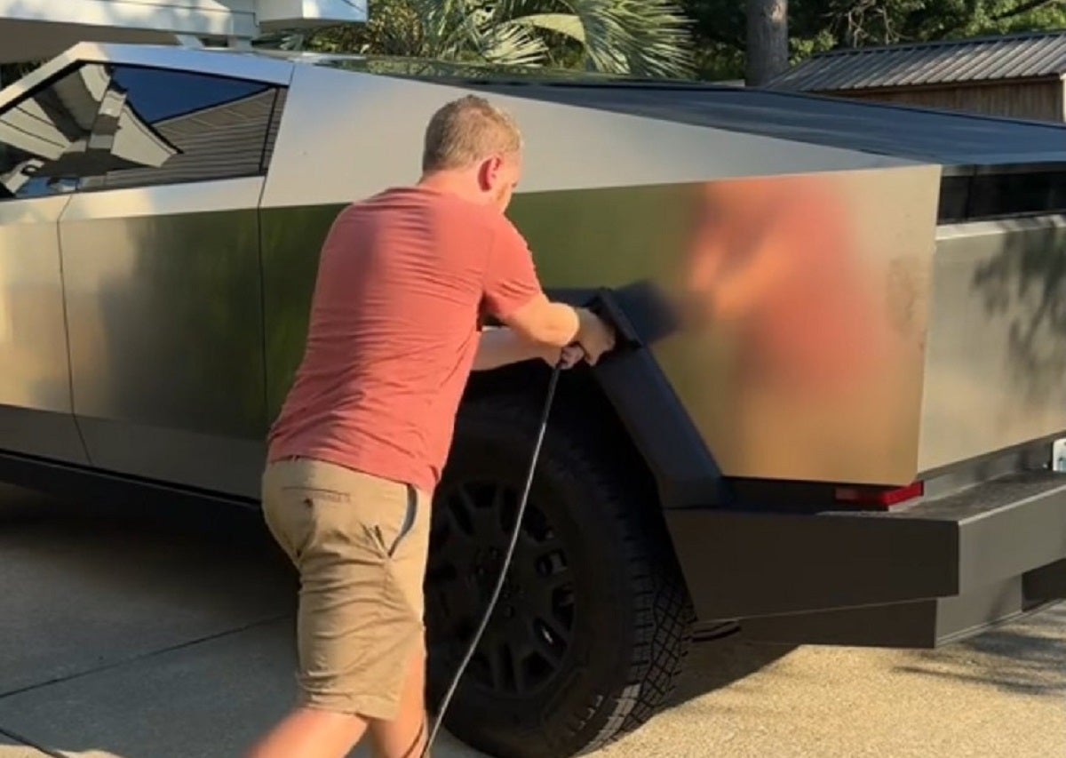 A viral TikTok shows a frustrated Tesla owner trying to figure out what to do when his charging cable gets stuck in his Cybertruck.
